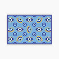 Patterned blue paper placemat with eye design on a blue background