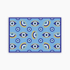 Patterned blue paper placemat with eye design on a blue background