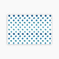 Pattern of blue watercolor dots on a white background printed on a paper placemat