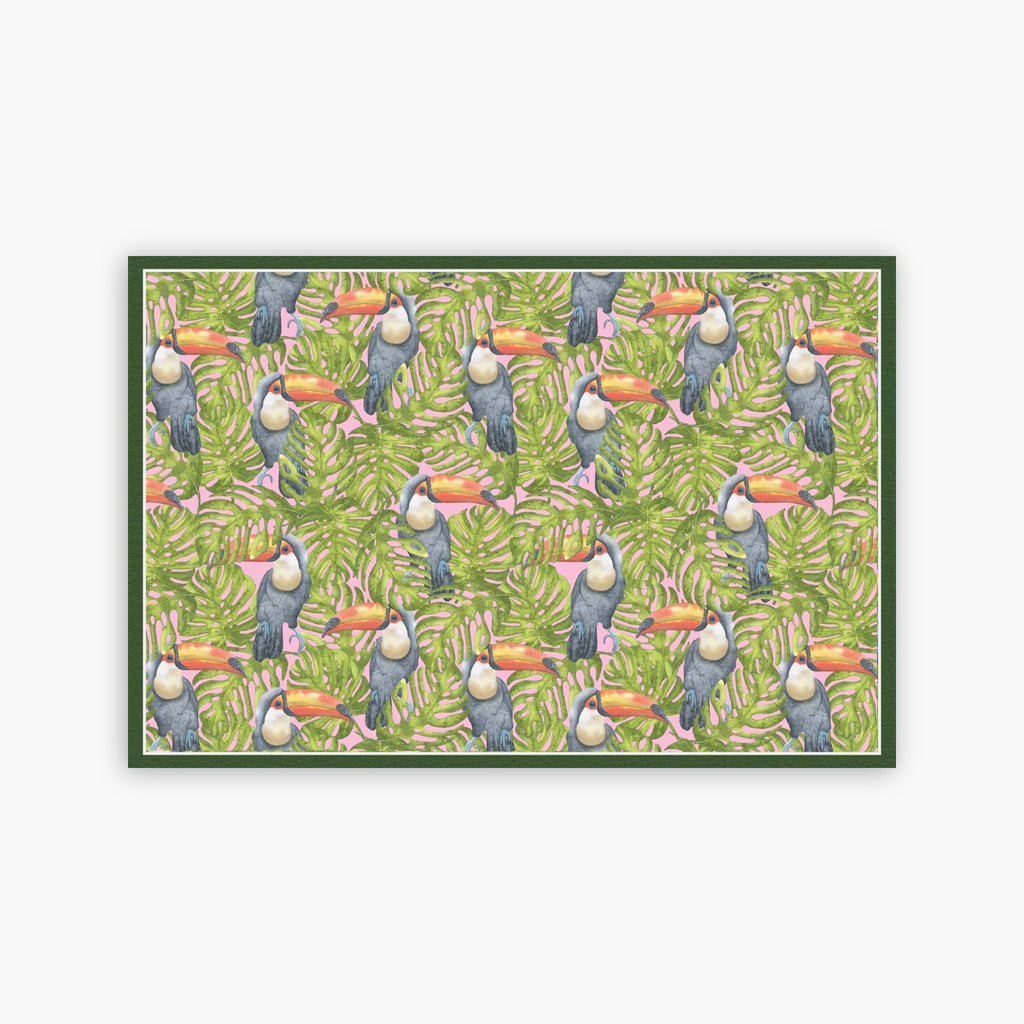 Pattern of toucans and leaves on a green background printed on a paper placemat