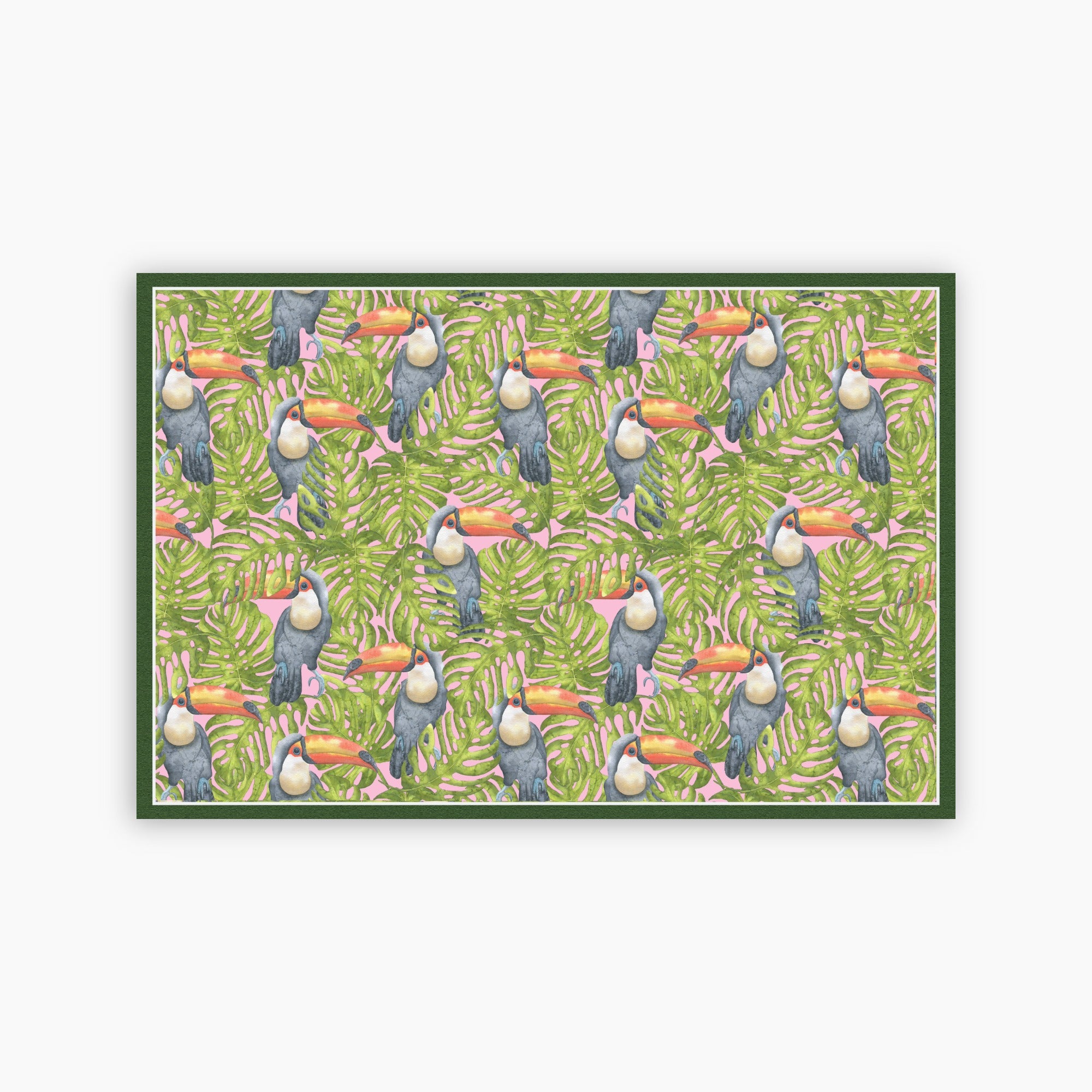 Pattern of toucans and leaves on a green background printed on a paper placemat