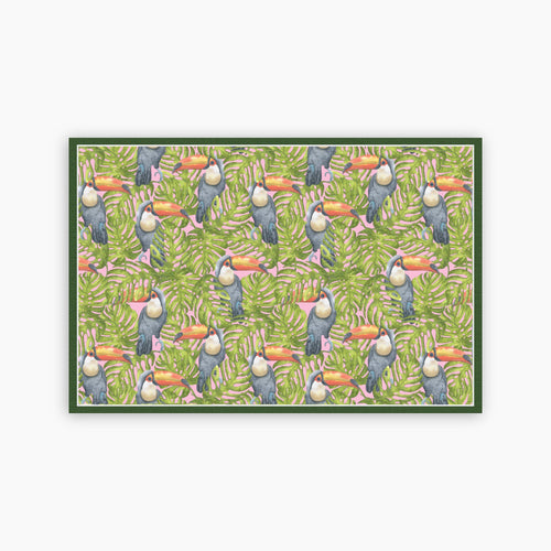 Pattern of toucans and leaves on a green background printed on a paper placemat