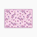 Floral patterned paper placemat with pink and purple flowers on a pink background