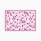 Floral patterned paper placemat with pink and purple flowers on a pink background