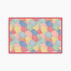 Colorful geometric umbrella patterned rug with a red border on a white background