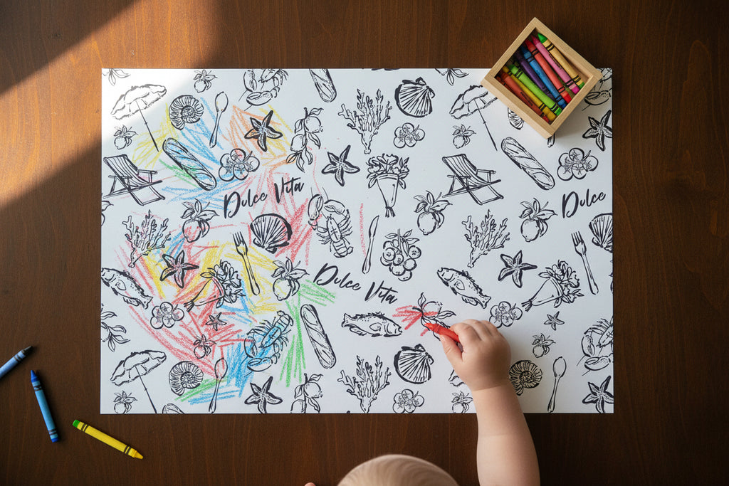 Child coloring a beach-themed coloring book with crayons on a wooden table.