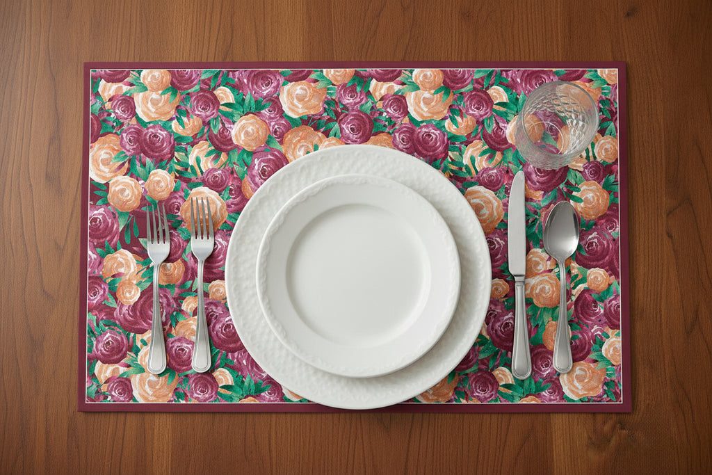 Floral placemat with a plate, cutlery, and flowers on a wooden surface