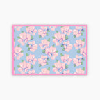 Floral patterned fabric with pink flowers on a blue background