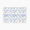 Patterned paper with blue flowers and ribbons on a white background