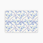 Patterned paper with blue flowers and ribbons on a white background