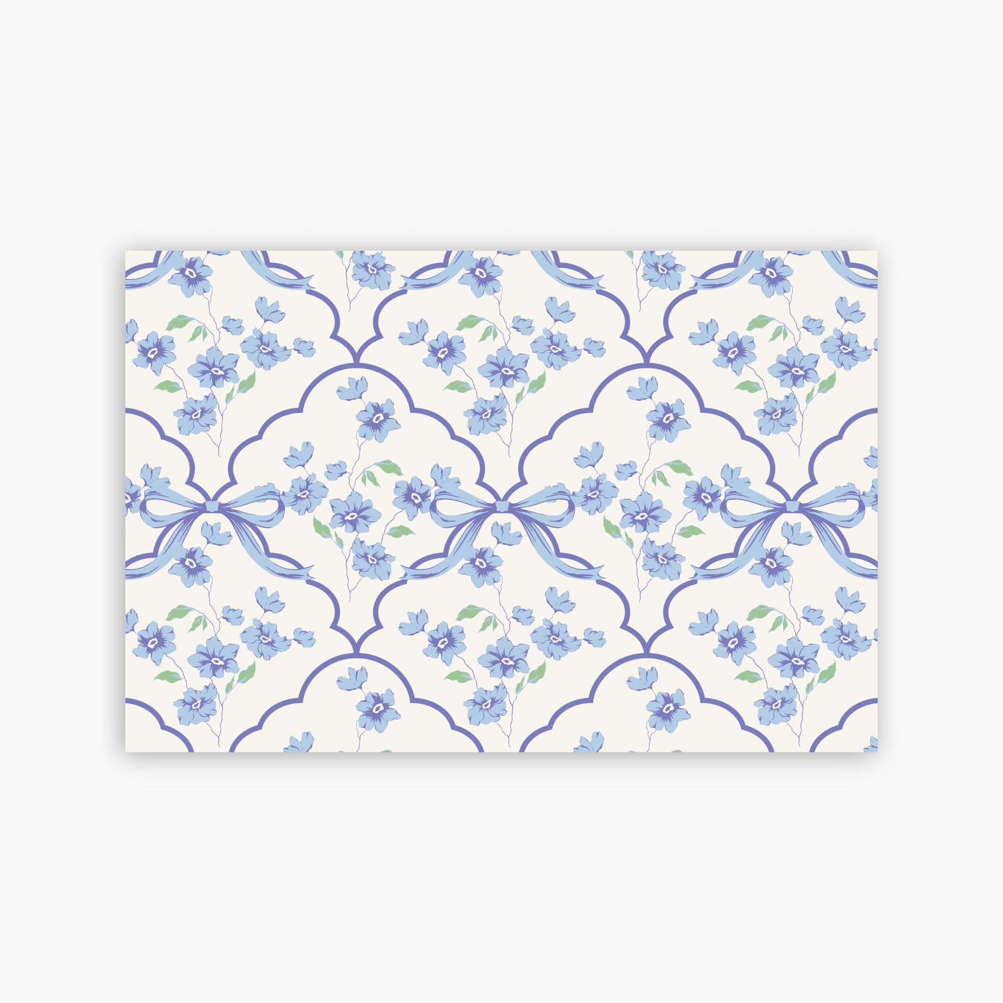 Patterned paper with blue flowers and ribbons on a white background