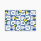 Pattern of blue and white tiles with yellow lemons on a white background